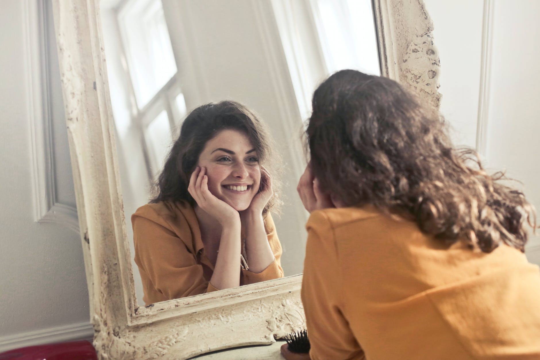 photo of woman looking at the mirror motivation
