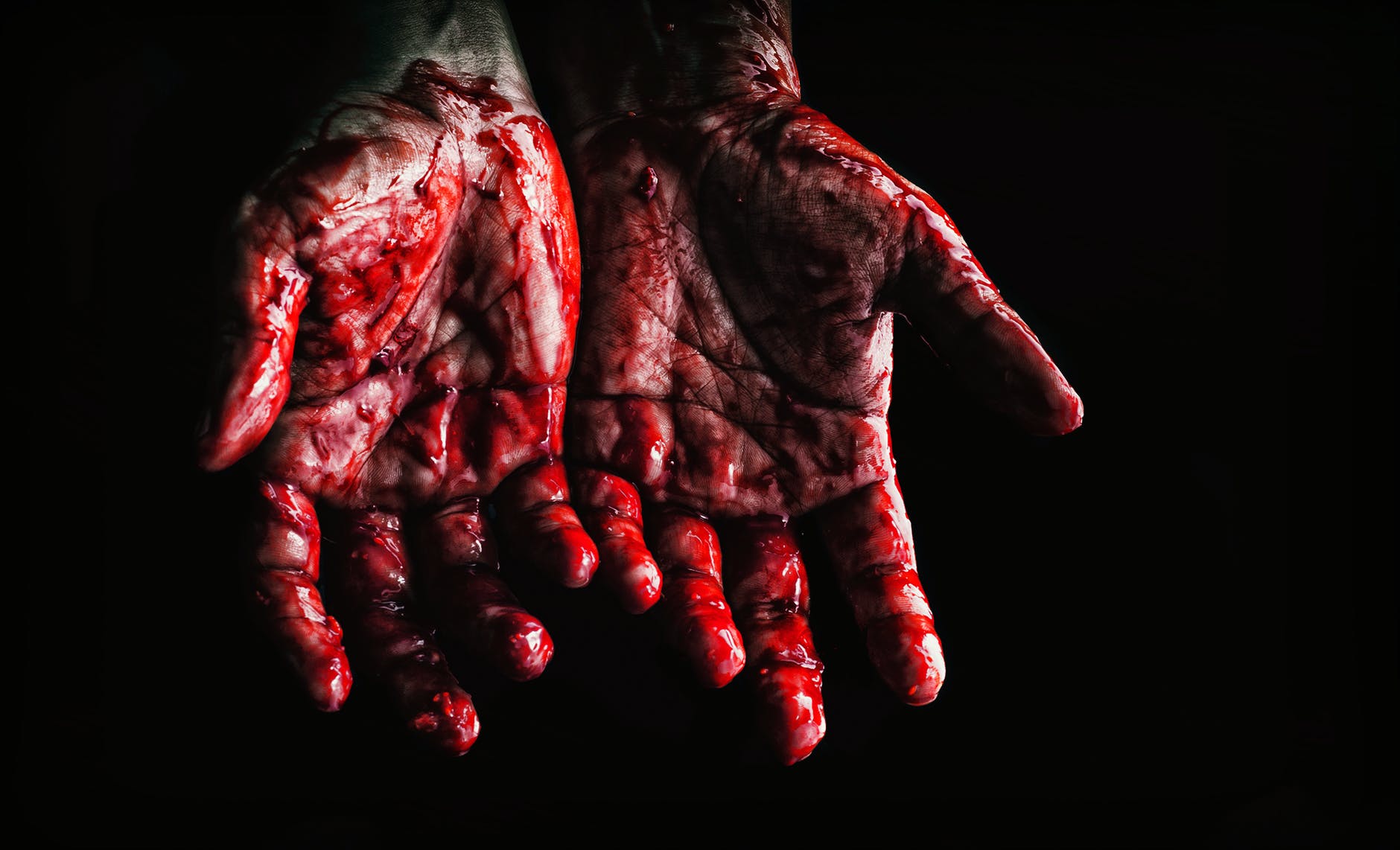 person s hands covered with blood