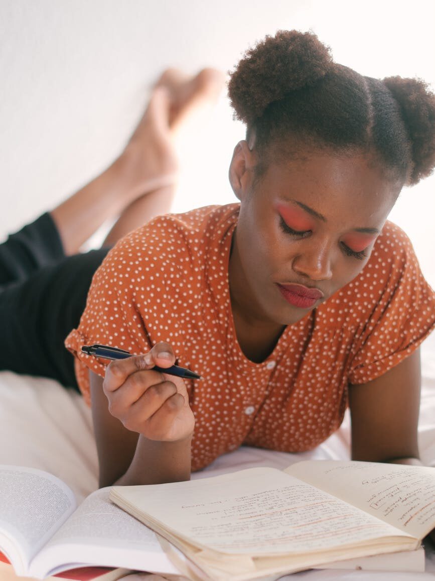 photo of woman holding a pen healing your inner child journal prompts